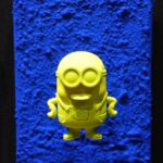 Seb Machten contemporary pop art sculpture with fluorescent orange minion-inspired figure on ultramarine textured surface