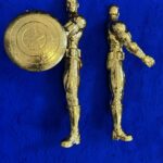 Seb Machten contemporary artwork with two gold superhero figures back to back on deep ultramarine surface