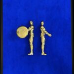 Seb Machten contemporary artwork with two gold superhero figures back to back on deep ultramarine surface