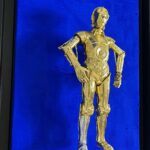 Seb Machten contemporary artwork with gold humanoid robot inspired by C-3PO on deep ultramarine background