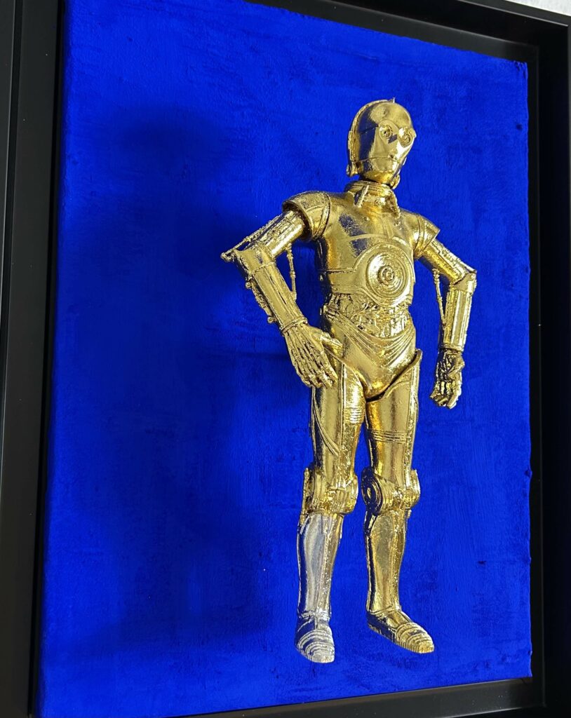 Seb Machten contemporary artwork with gold humanoid robot inspired by C-3PO on deep ultramarine background