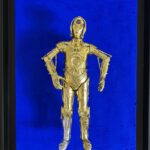 Seb Machten contemporary artwork with gold humanoid robot inspired by C-3PO on deep ultramarine background