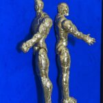 Seb Machten contemporary artwork with two gold superhero figures back to back on deep ultramarine surface