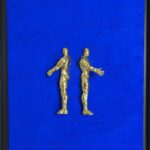 Seb Machten contemporary artwork with two gold superhero figures back to back on deep ultramarine surface