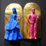 Seb Machten contemporary artwork with blue and pink doll figures on gold leaf skateboards
