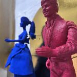 Seb Machten contemporary artwork with blue and pink doll figures on gold leaf skateboards