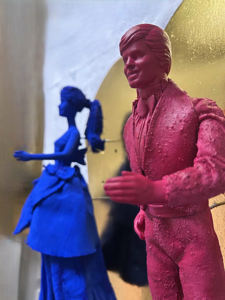 Seb Machten contemporary artwork with blue and pink doll figures on gold leaf skateboards