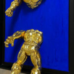 Seb Machten contemporary artwork with fragmented golden hero figure on deep ultramarine surface