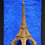 Seb Machten contemporary artwork with gold Eiffel Tower sculpture on deep ultramarine blue surface