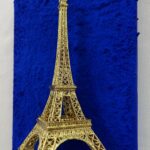 Seb Machten contemporary artwork with gold Eiffel Tower sculpture on deep ultramarine blue surface