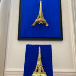 Seb Machten contemporary artwork with gold Eiffel Tower sculpture on deep ultramarine blue surface