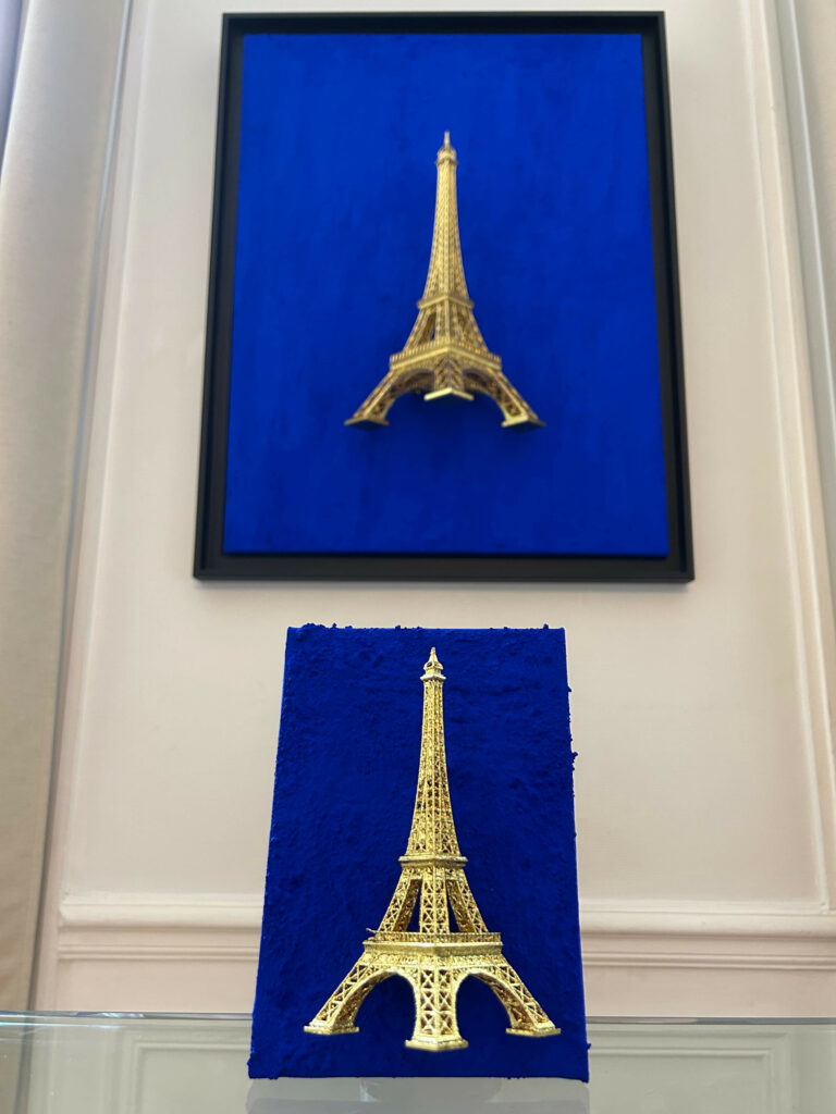 Seb Machten contemporary artwork with gold Eiffel Tower sculpture on deep ultramarine blue surface