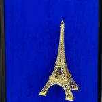 Seb Machten contemporary artwork with gold Eiffel Tower sculpture on deep ultramarine blue surface