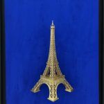 Seb Machten contemporary artwork with gold Eiffel Tower sculpture on deep ultramarine blue surface