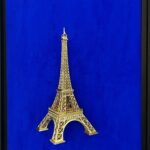 Seb Machten contemporary artwork with gold Eiffel Tower sculpture on deep ultramarine blue surface