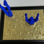Seb Machten Contemporary pop art sculpture of two blue flying figures diving and emerging on textured gold background, exploring inner journey and self-reflection