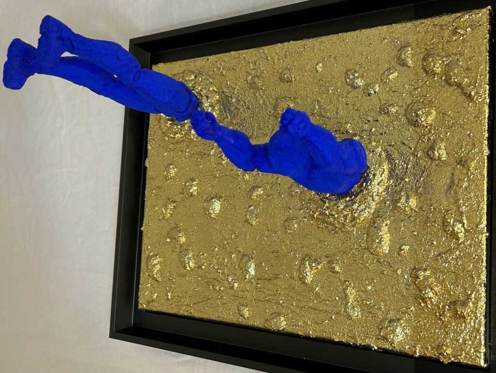 Seb Machten Contemporary pop art sculpture of two blue flying figures diving and emerging on textured gold background, exploring inner journey and self-reflection