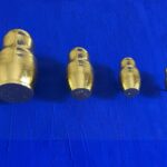 Seb Machten contemporary artwork with gold matryoshka figures evolving in size on deep ultramarine surface