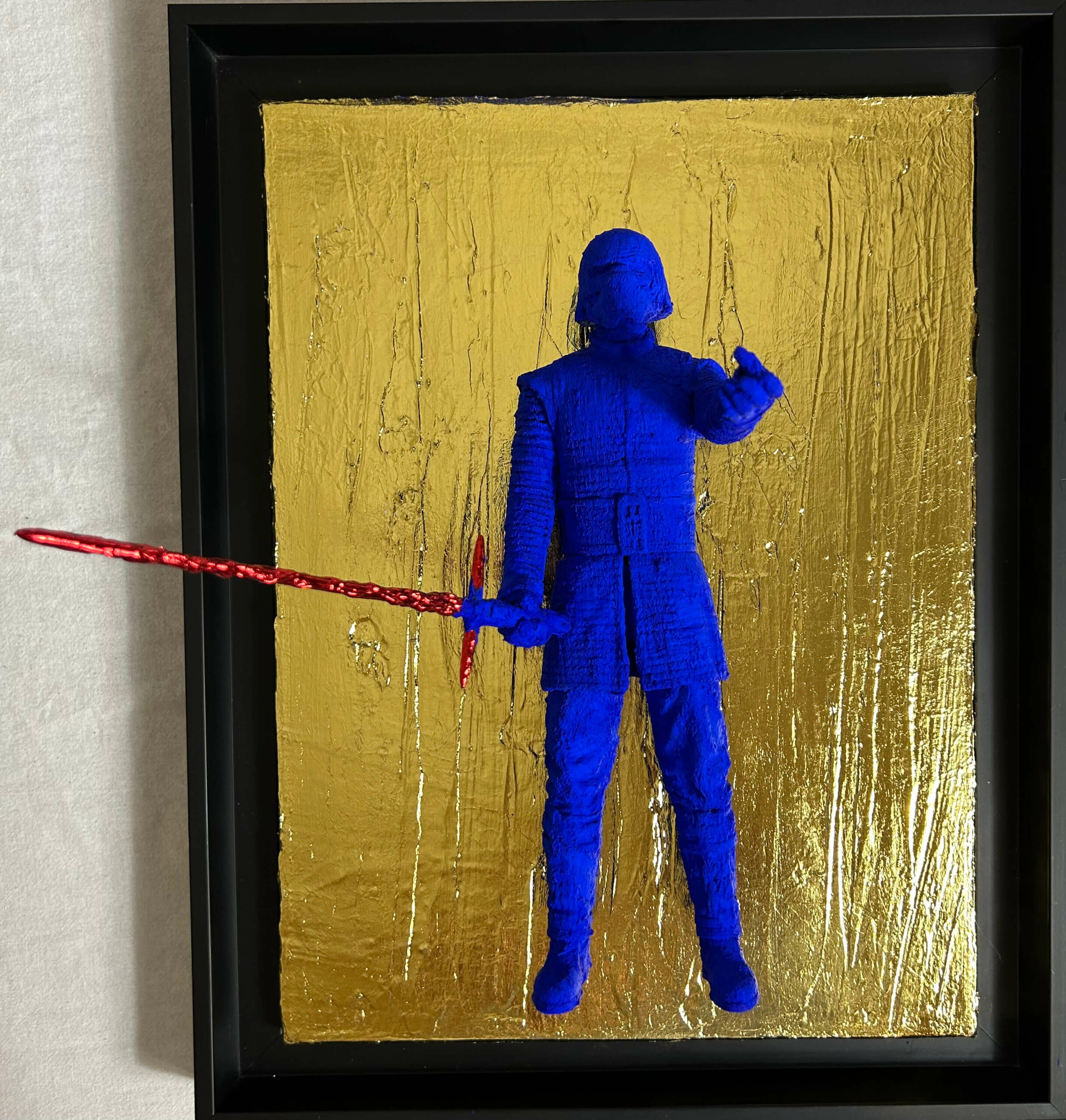 Seb Machten contemporary artwork with ultramarine Kylo Ren inspired figure and red lightsaber on gold leaf surface