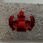 Seb Machten contemporary artwork with red starfighter built from construction bricks projecting from textured silver surface