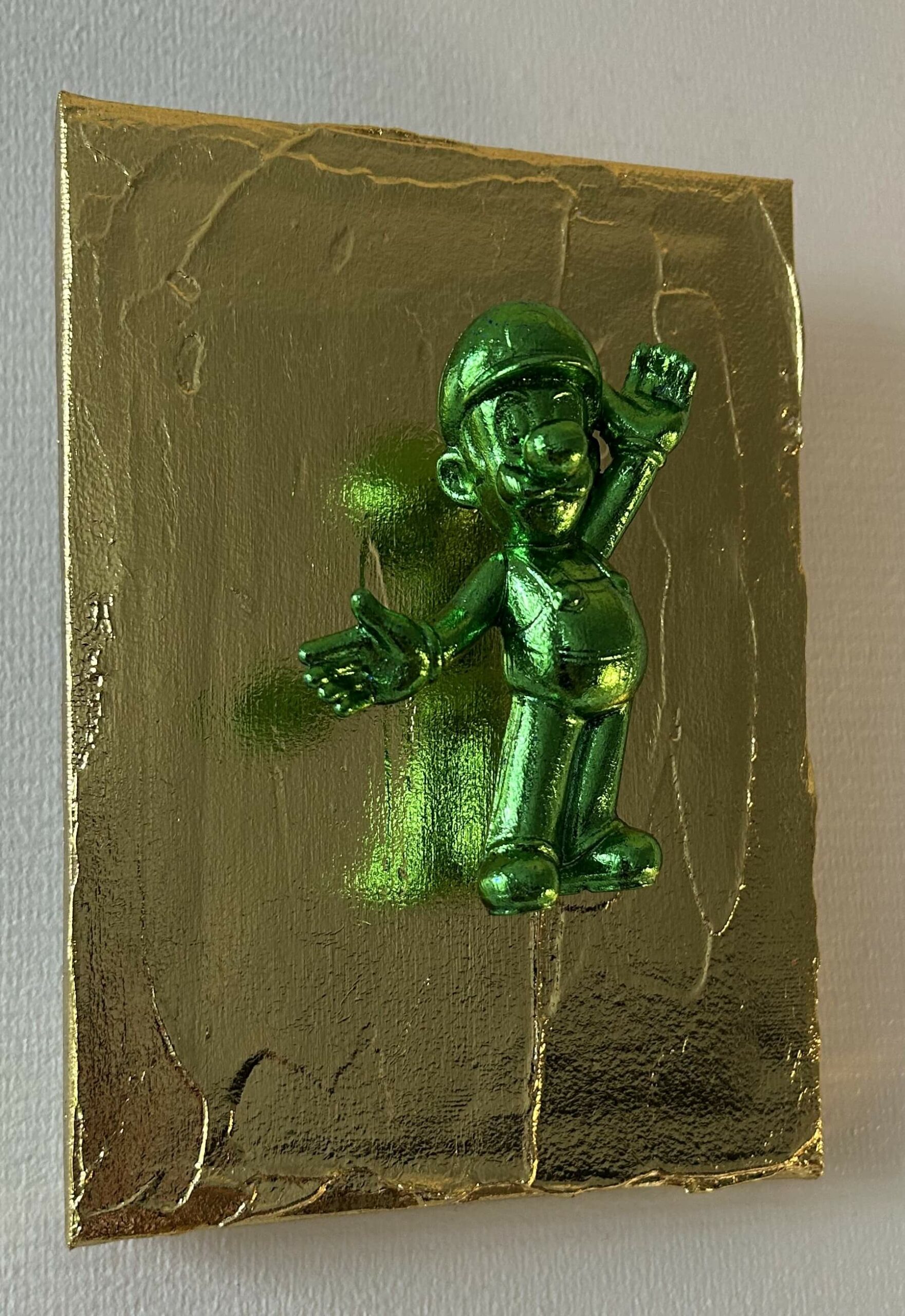 Seb Machten contemporary pop art sculpture with metallic green Luigi-inspired figure on gold textured surface