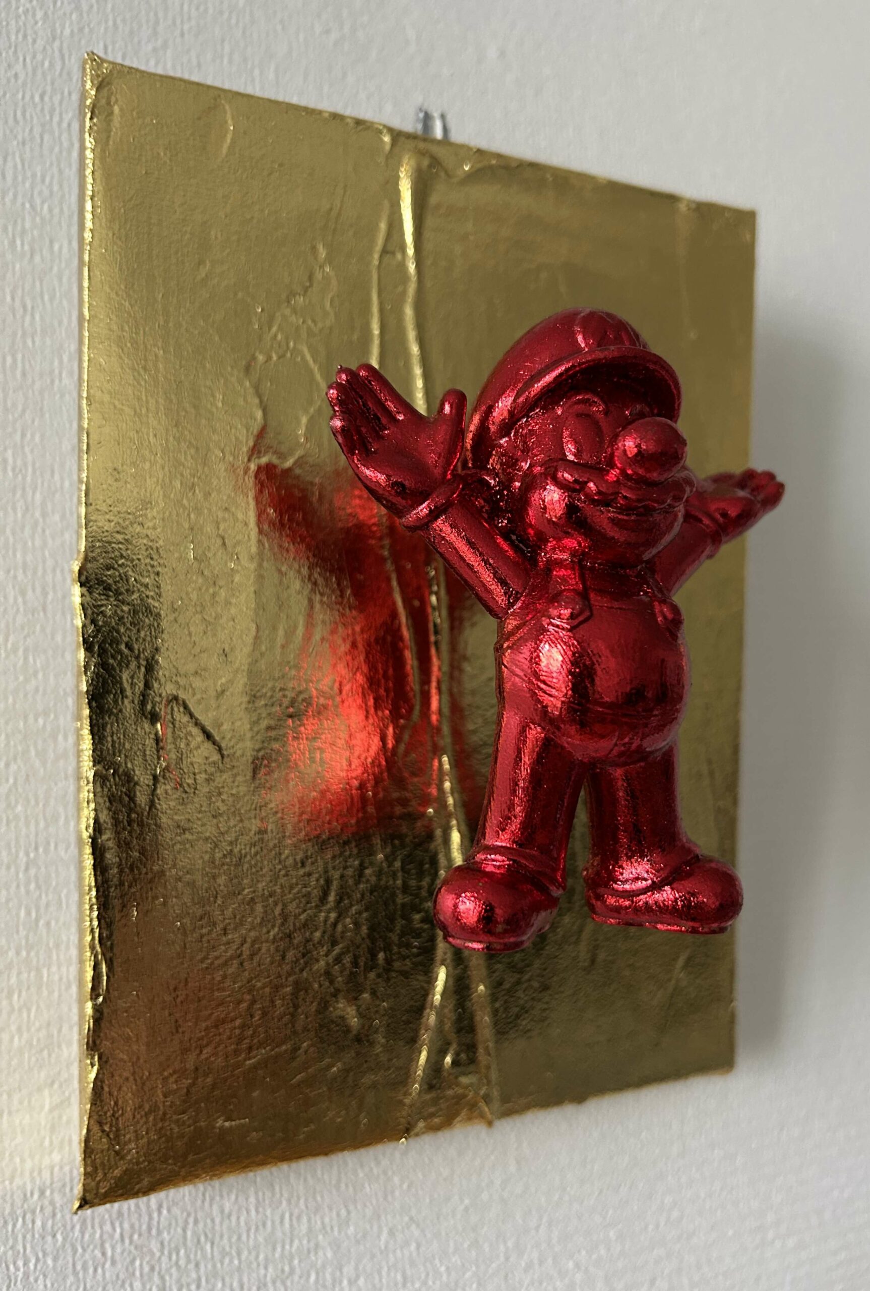 Seb Machten contemporary pop art sculpture with metallic red Mario-inspired figure on gold textured surface