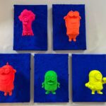 Seb Machten contemporary pop art sculpture with fluorescent orange minion-inspired figure on ultramarine textured surface