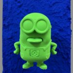 Seb Machten contemporary pop art sculpture with fluorescent orange minion-inspired figure on ultramarine textured surface