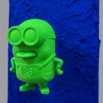 Seb Machten contemporary pop art sculpture with fluorescent orange minion-inspired figure on ultramarine textured surface