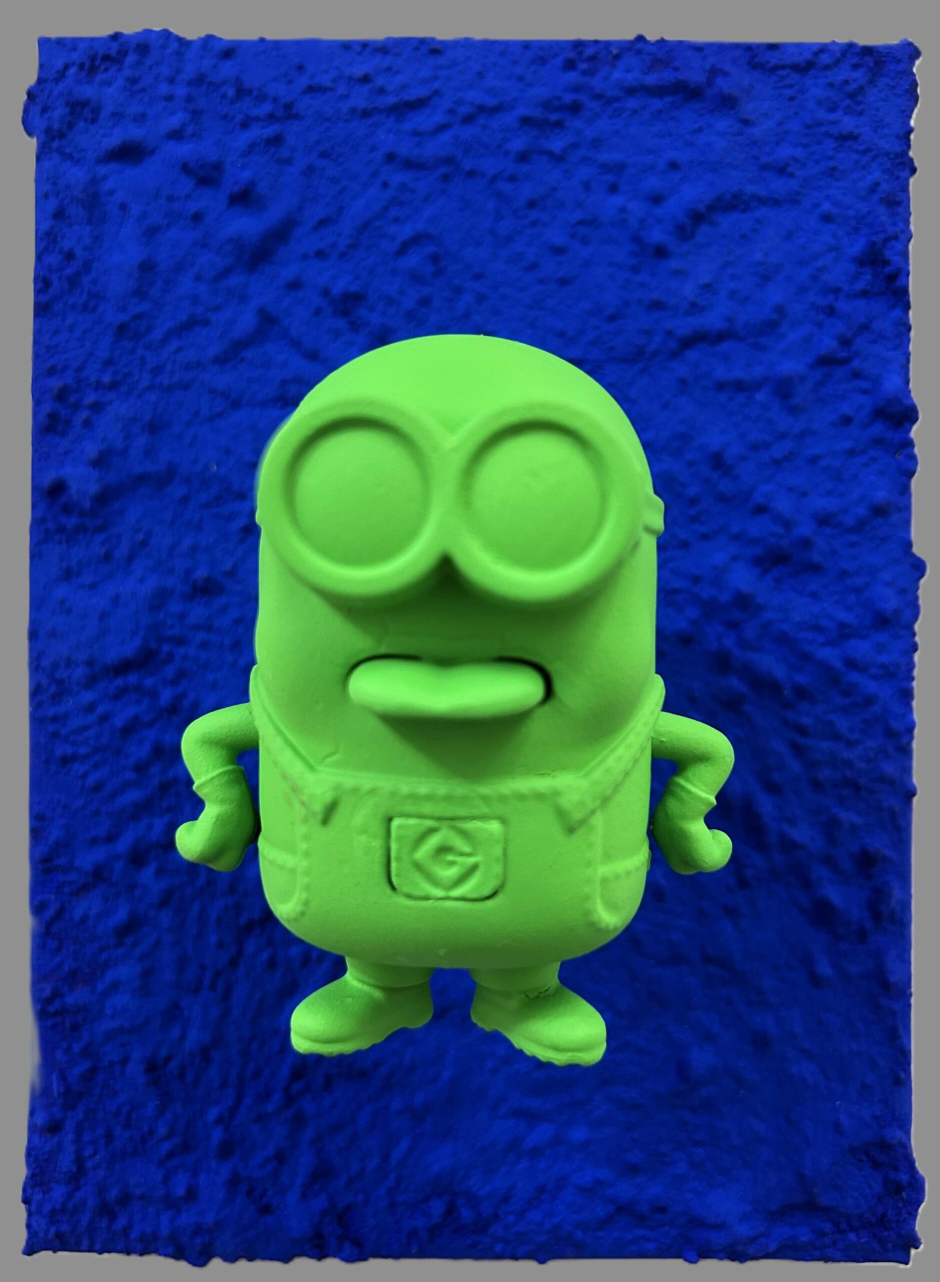 Seb Machten contemporary pop art sculpture with fluorescent orange minion-inspired figure on ultramarine textured surface