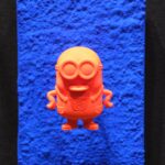 Seb Machten contemporary pop art sculpture with fluorescent orange minion-inspired figure on ultramarine textured surface